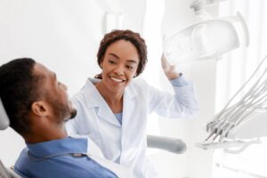 Happy dentist with smiling patient