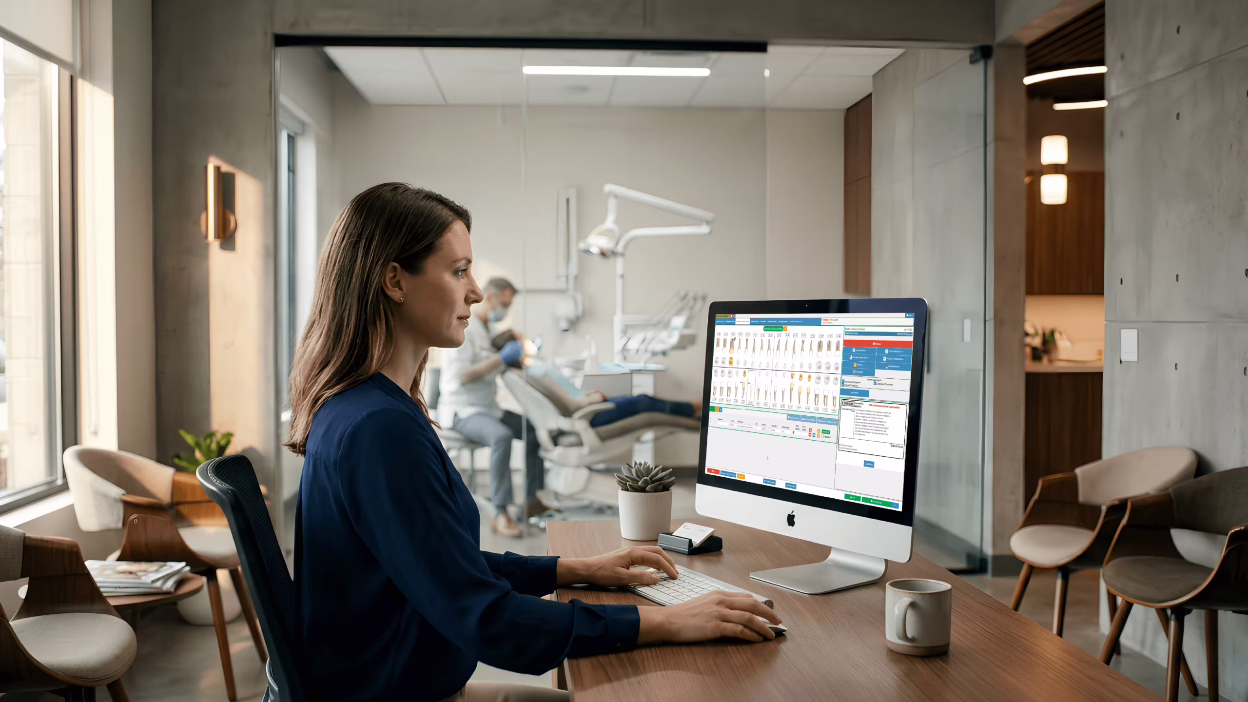 Dental staff using dental office practice management software at the front desk